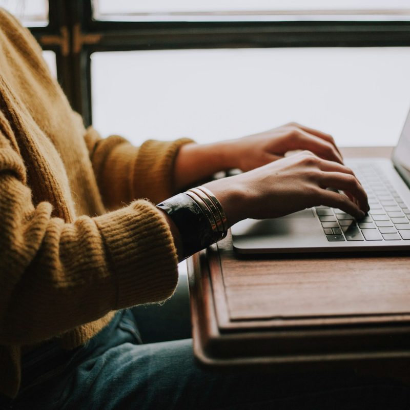 person sitting front of laptop