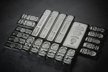 a pile of silver bars sitting on top of a table