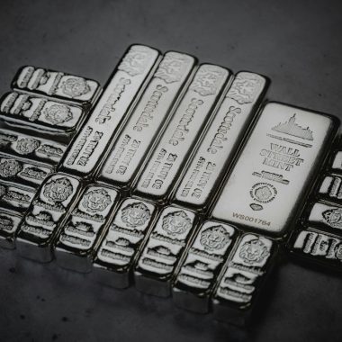 a pile of silver bars sitting on top of a table