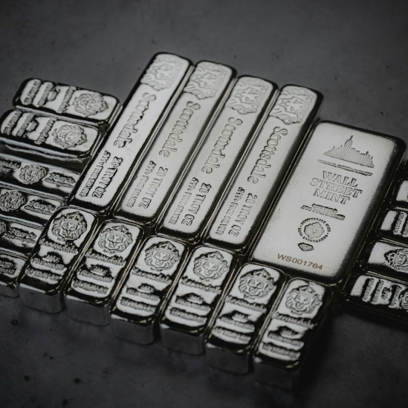 a pile of silver bars sitting on top of a table