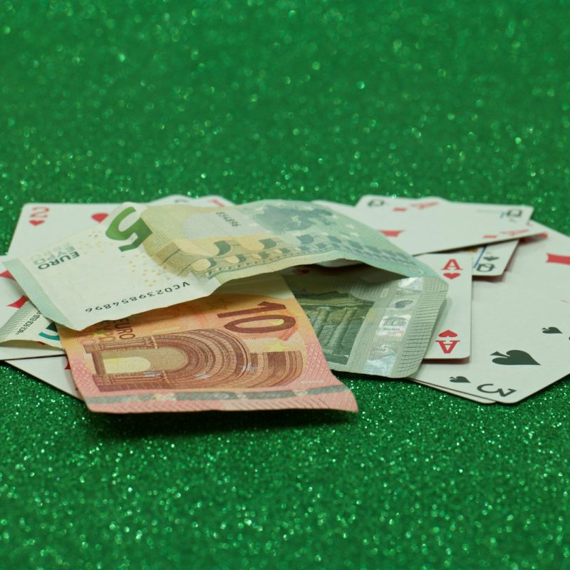 a pile of playing cards sitting on top of a green table
