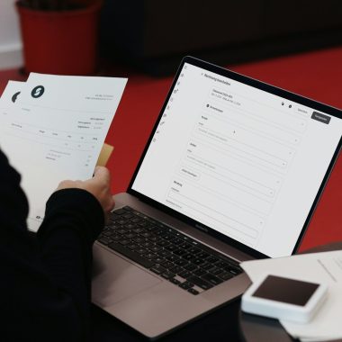 A person sitting at a desk with a laptop and papers